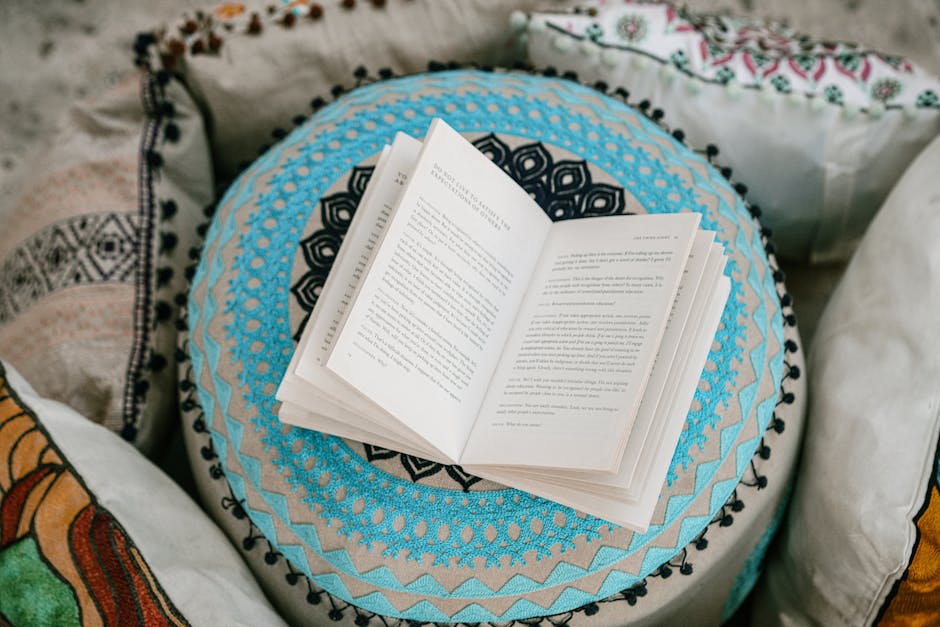 An open book lies on beautiful patterned cushions, inviting calm and relaxation. Ideal for book lovers or mindfulness concepts.