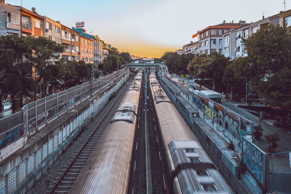 Vibrant urban scene featuring fast-moving trains under a sunset in Istanbul, Türkiye.